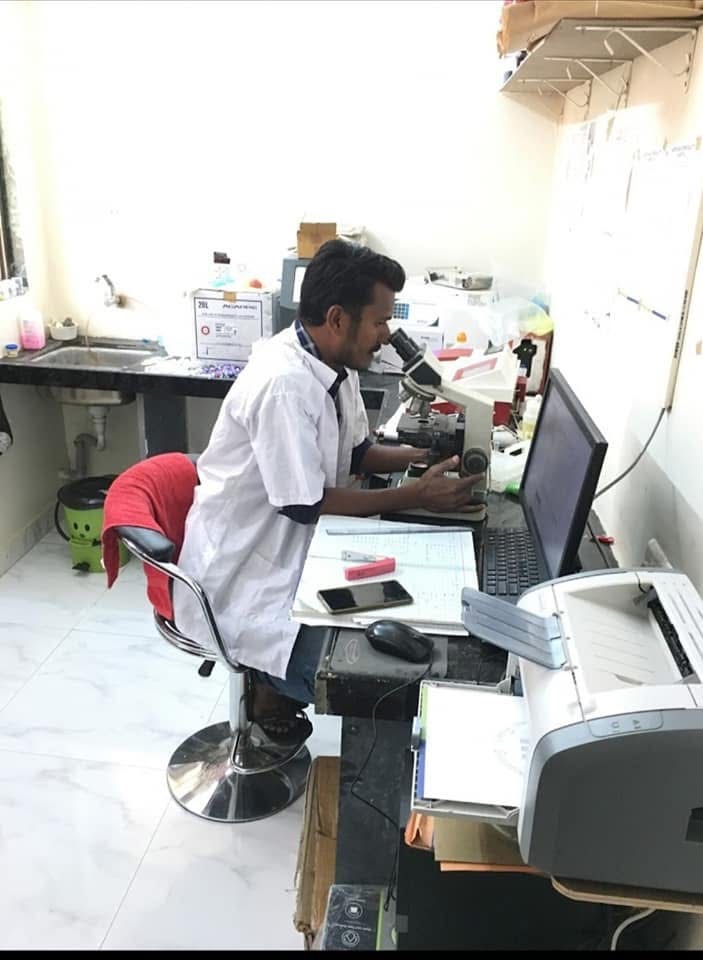 Lab technician at a microscope